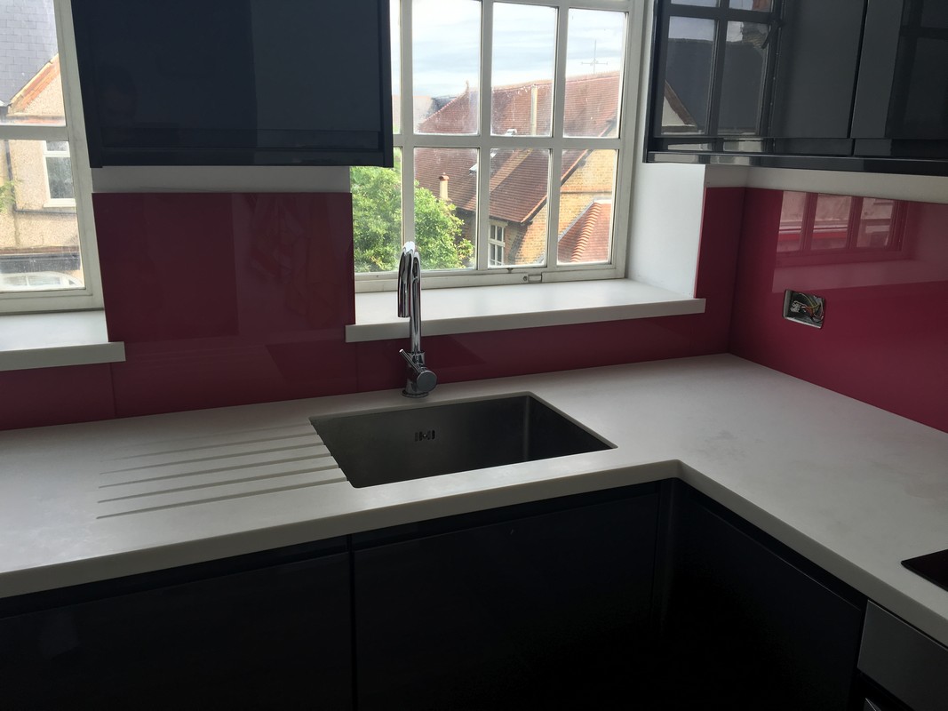 Deep plum coloured glass splashback in modern Plaistow kitchen